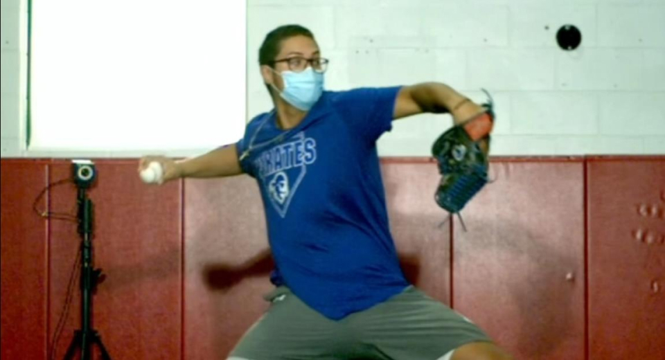 highschool baseball pitcher next to highspeed camera