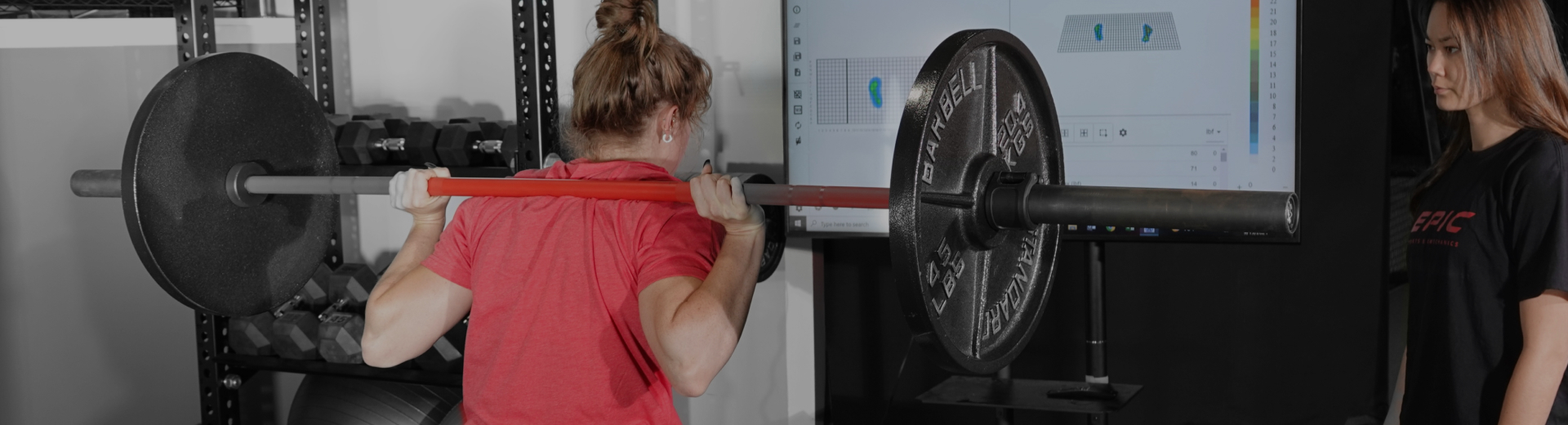 female teen lifting weights with sports athletic coach